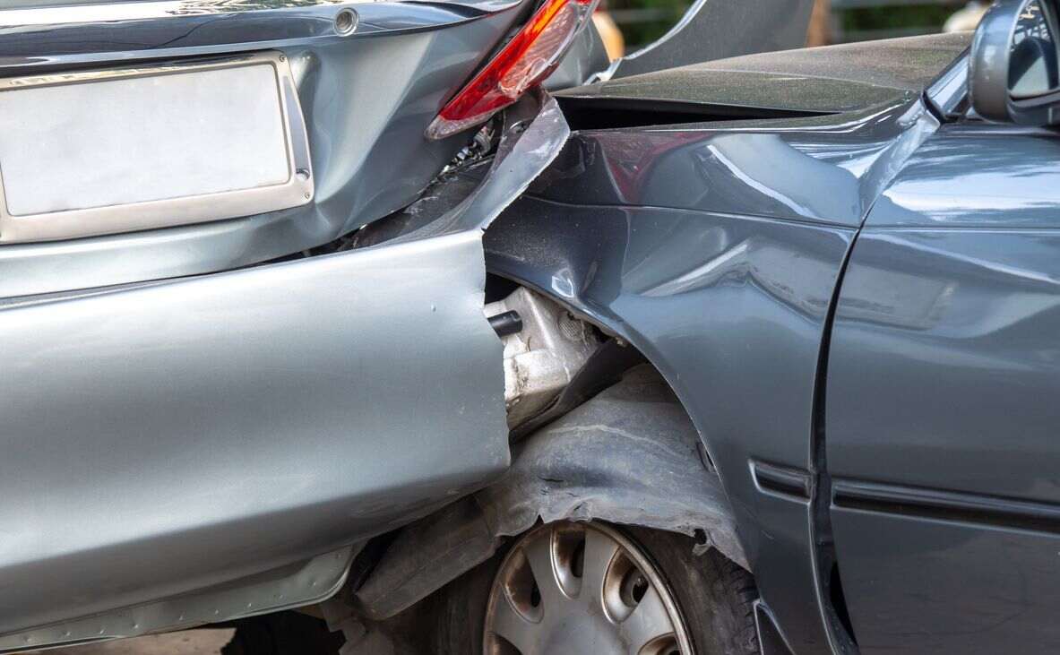 Heavily damaged vehicles after a rear-end collision, highlighting the challenges in establishing clear fault in these types of accidents, particularly in California.